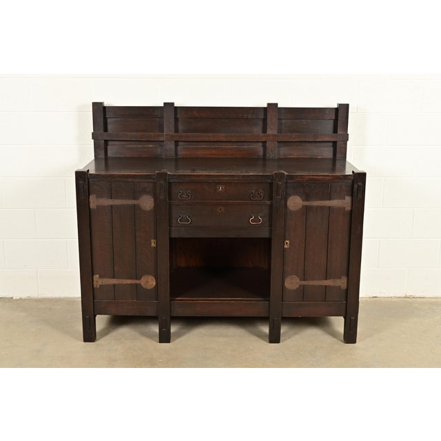 An exceptional antique Mission or Arts & Crafts period strap hinge eight-leg sideboard, buffet server, or bar cabinet In...