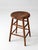 This antique wood stool features a simple country form with warm, primitive character. The gently rounded seat, turned...