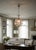 An enchanting vintage mid-century sphere or cage chandelier, heavily influenced by the iconic designs of Maison Baguès....