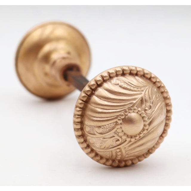 This Vernacular style antique brass Corbin knob set was made in 1895. The knob has an asymmetrical design with a polished...
