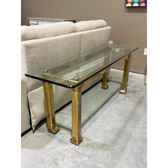A distinguished Mid-Century Modern console table attributed to Mastercraft, celebrated for its architectural proportions...