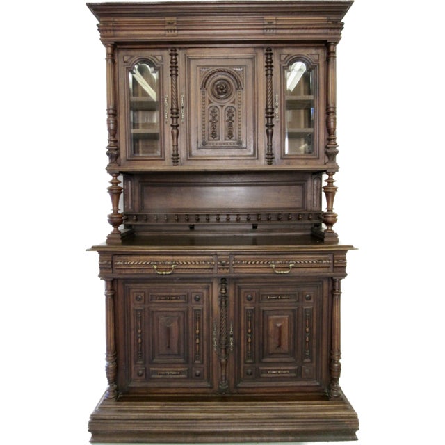 This is a Highly Carved Antique English Two Piece Walnut Court Cupboard.China Cabinet with great storage. The cupboard...