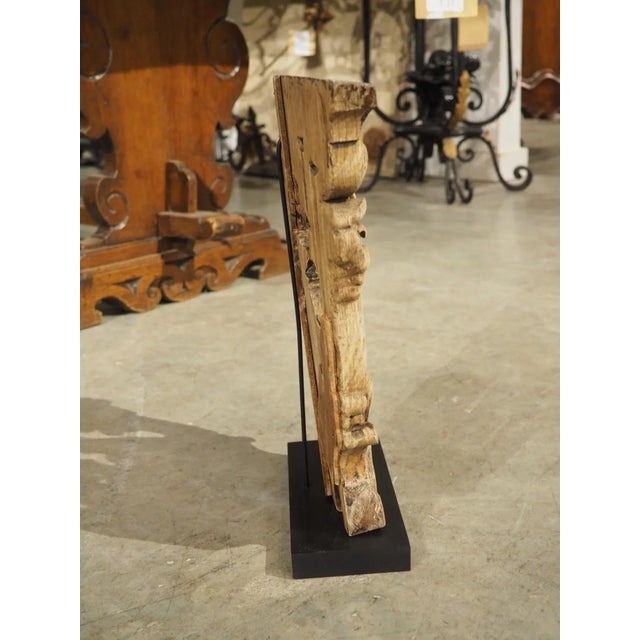Most likely originally part of a larger installation or highly carved furniture, this charming oak capital is from...