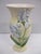 A tall and beautiful art pottery blue iris vase on an antique white finish. This vase is in good vintage condition with no...