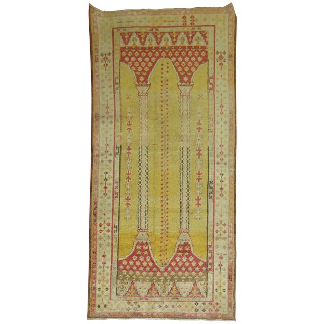 Highly decorative Turkish rug with a double column prayer niche design on a sunny yellow ground, circa 1920. Measures:...