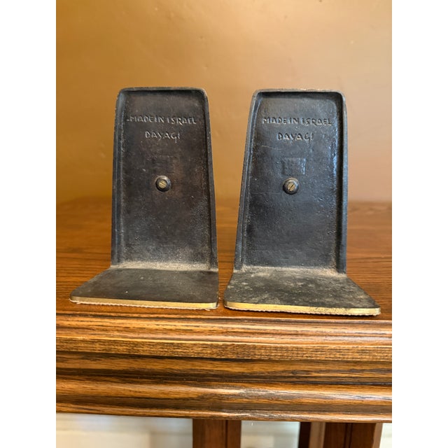 Pair of enameled brass bookends with Holy Family relief panels. Signed Dayagi, Made in Israel.