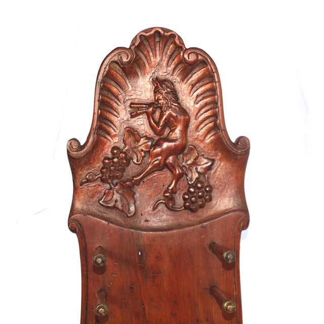An antique vertical carved wooden plate rack. Can also be used horizontally on a table. Bacchus is carved at the top and...
