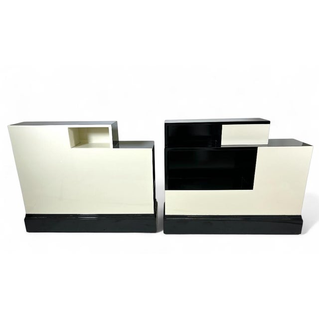 Offering a pair of rare, uniquely designed Stepped Art Deco Stands in Ebony and Ivory. Each shelf/stand has display...