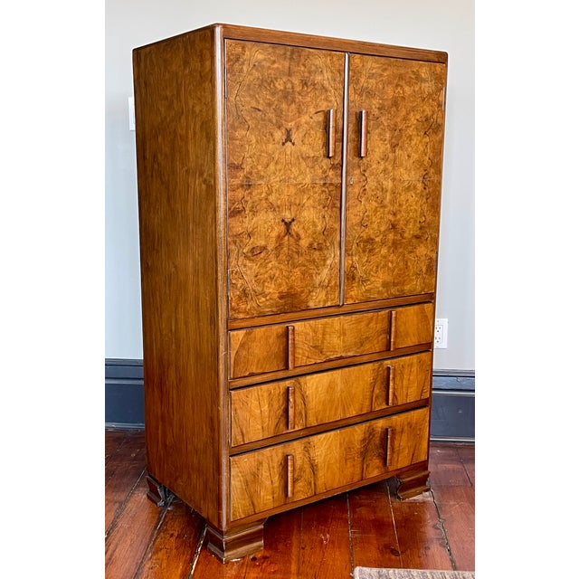 Vintage Art Deco/Moderne Walnut Highboy Dresser with a book-matched burl walnut veneer front. Upper half of the cabinet...