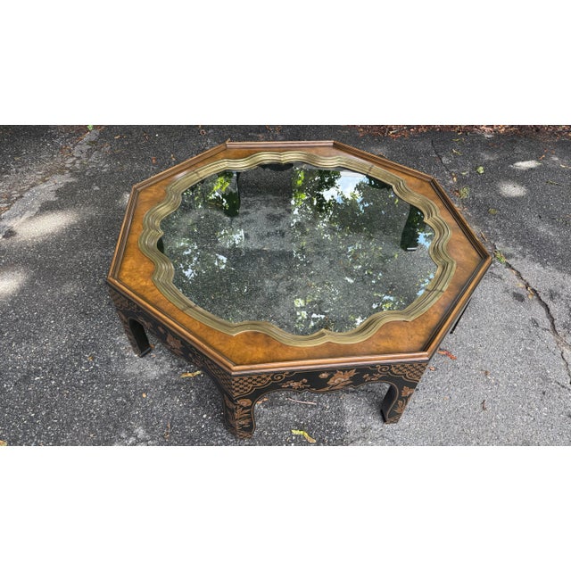 A striking vintage octagonal coffee table that blends elegant form with exquisite Chinoiserie detailing. The standout...
