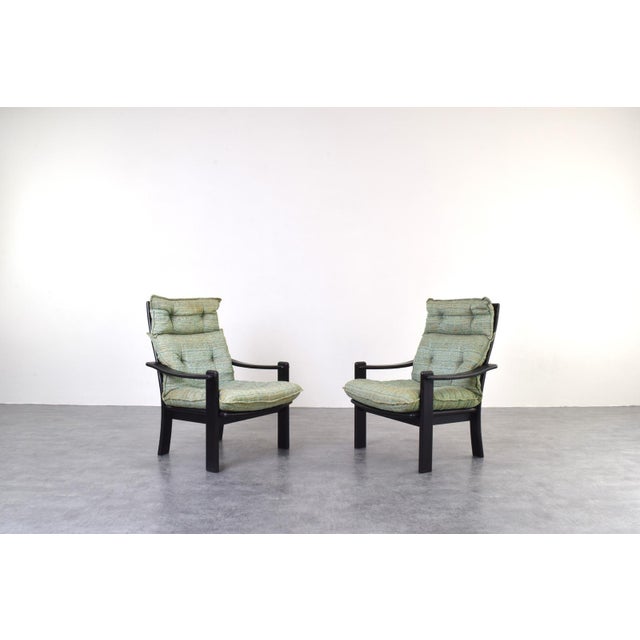 This pair of armchairs and a coffee table were made in Denmark in the 1970s. The wooden elements are made of solid ash...