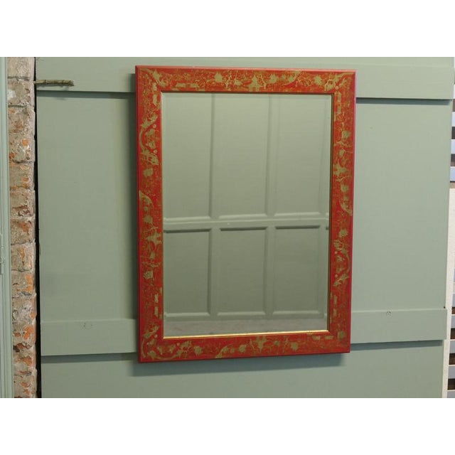 Red and Gold Lacquer Chinoiserie Wall Mirror This charming mirror has delightfully etched and painted gold chinoiserie...