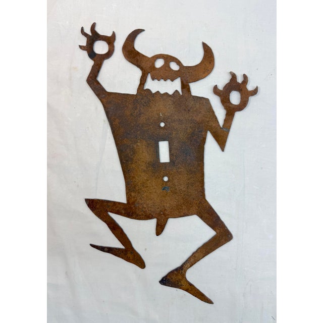 This large antique hand-cut steel monster silhouette wall switch cover is a unique and handmade piece suitable for any...