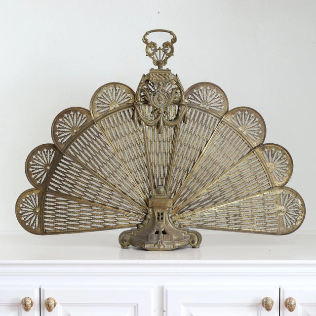 Drop dead gorgeous brass peacock fireplace screen in solid brass with intricately cut filigree fan blades that splay out...