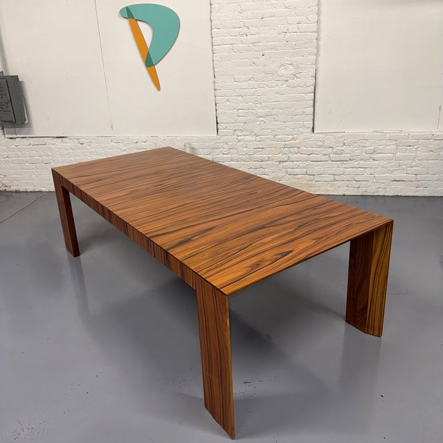 The El Dom Rosewood Dining Table is a minimalist modern dining table designed by Hannes Wettstein for Cassina in 2005....