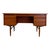 This mid-century modern teak executive desk features a double-pedestal design supported by tapered, sculptured legs. The...