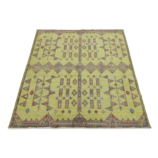 Elevate your space with this Modern Khotan Style wool rug, featuring a vibrant chartreuse green field that revitalizes...