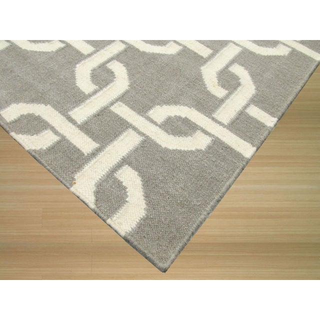 Sloane Cozy Grey Flatweave Wool Rug, Country of Origin: India. This contemporary flatweave piece utilizes a sophisticated...