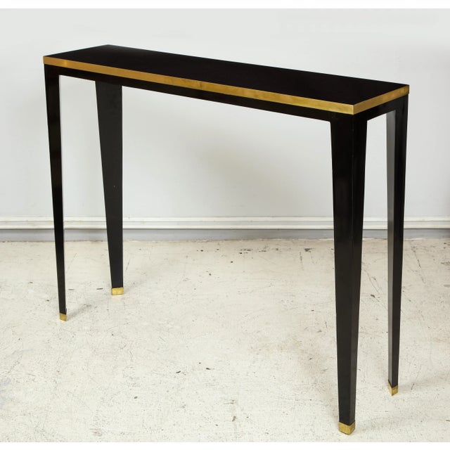 Bespoke Ebonized brass-banded consoles on tapered legs Measures: H 36.5 in. x W 47 in. x D 11.5 in. Please view our other...
