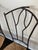 An attractive set of four dining chairs pairing slender, dark metal frames with warm natural woven seats. The chairs are...