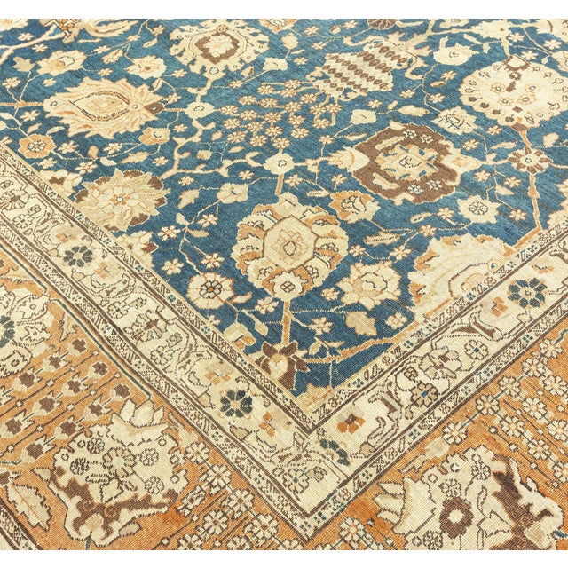 An early 20th century Persian Tabriz antique rug, the royal blue field with a vase design with an allover trellis of...