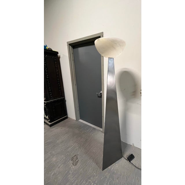 Sculptural Spanish floor lamp by Sarreal, Art i Llum S.A., featuring a dramatically tapered brushed steel column topped by...