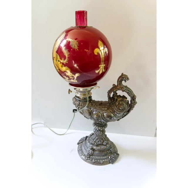 A very fine late 19th century Harvard Student lamp featuring a silver plated cast metal cornucopia shaped body. Affixed...