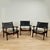 Chic set of three mid-century safari-style chairs crafted in richly grained rosewood, featuring sleek stylized frames,...