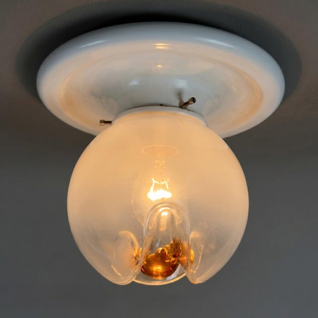 A refined and iconic lighting fixture with a strong visual impact. This rare ceiling light perfectly embodies the...