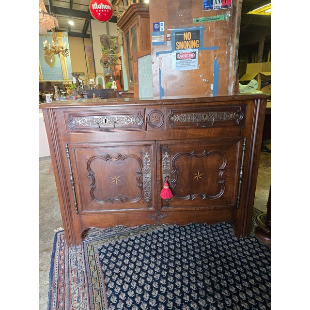 Antique French walnut buffet dating to the mid-19th century, reflecting Louis XVI to early Empire stylistic influence. The...