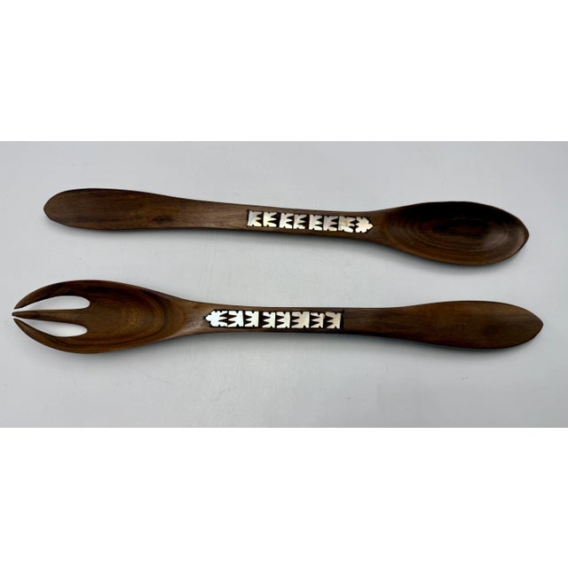 Vintage hand carved wood salad spoon and fork set with mother of pearl inlay. MCM