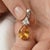 This radiant pendant features a glowing Citrine, a gemstone cherished for its warm, sun-kissed golden hues and vibrant...