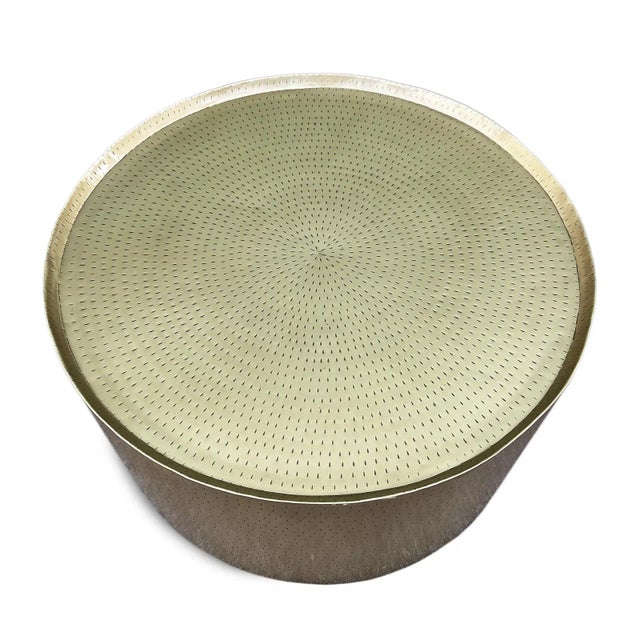 Modern hand hammered lightweight iron coffee table with luxurious antiqued brass finish. Simple round drum design with...