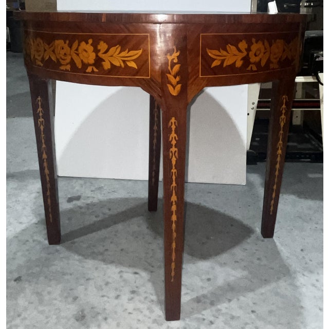 This elegant demi-lune console table features fine wood inlay and a versatile design that expands into a round dining...