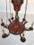 Gorgeous six light brass chandelier with antique red tole finish featuring detailed leaf cut-outs at the top. Created in...