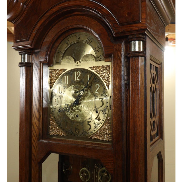An elegant expression of traditional American clockmaking, this Howard Miller “Marston” grandfather clock pairs a richly...