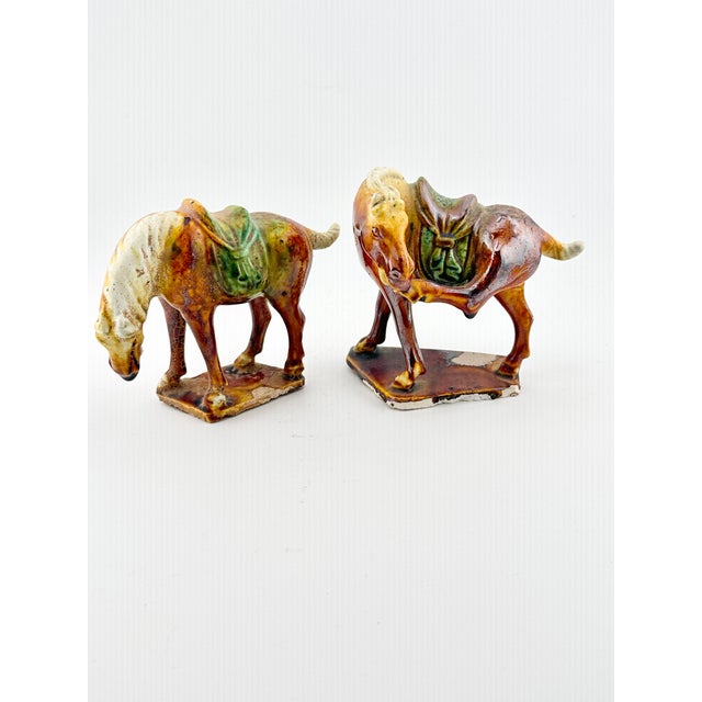 Add a touch of classical elegance to your home with this beautiful pair of vintage Chinese Tang-style horse figurines....