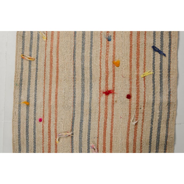 This is a vintage Turkish Oushak rug from the Mid 20th Century. The piece was hand-knotted.