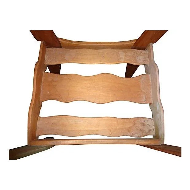 A sculptural modernist wooden bench. The bench is crafted of natural wood, with parts intentionally stained in yellow and...