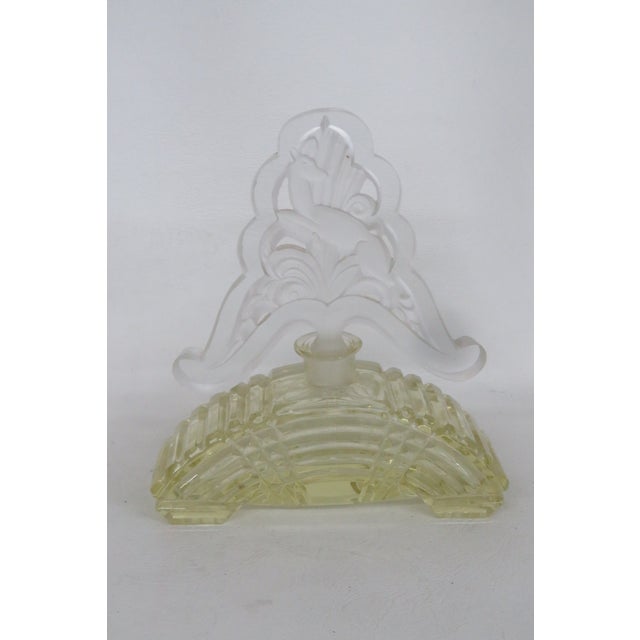 This lovely empty decorative perfume bottle is made out of carved yellow glass with a frosted glass stopper. Due to its...