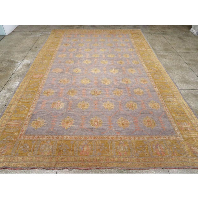 This wool pile, with symmetric knots on a wool foundation, features an unusual and highly desirable pale blue field that...