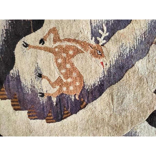 Spotted deer and crane, longevity symbols, inhabit a rocky mountainous beneath a brocade pattern sky, all within a...