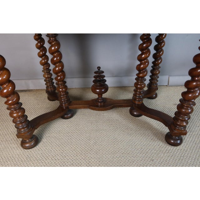 A Louis XIII style natural wood writing table with a large drawer in the apron, the top embossed with gilt-tooled leather....