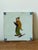 A charming pair of antique Delft-style ceramic tiles with hand-painted figural decoration and traditional corner...
