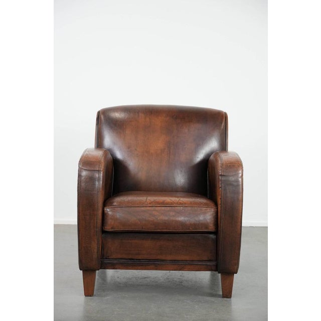 We are offering this beautifully shaped vintage sheepskin armchair with character and beautiful colors. A unique addition...