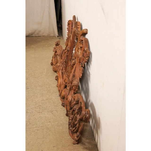 An Italian pierce-carved wood wall plaque in Sphinx motif from the early 19th century. This antique wall decoration from...