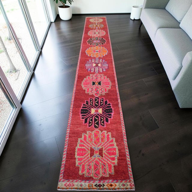 This exceptional vintage hand-knotted runner rug, originating from Southeastern Anatolia during the 1960s, presents a...