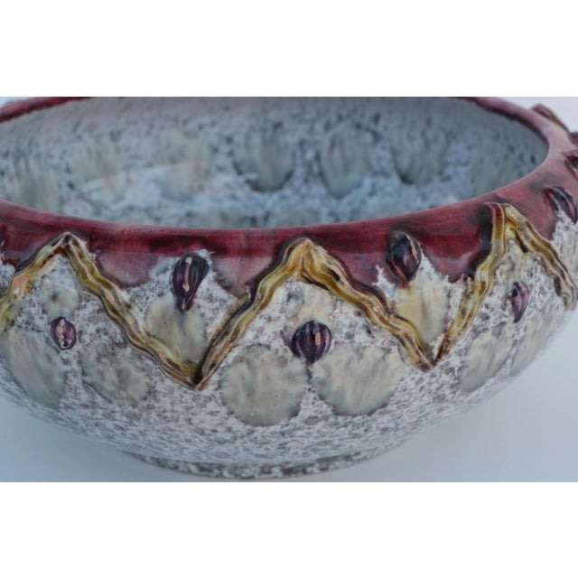 Vintage Italian art pottery bowl with a glossy white glaze featuring a hand built zigzag decoration and burgundy red rim....