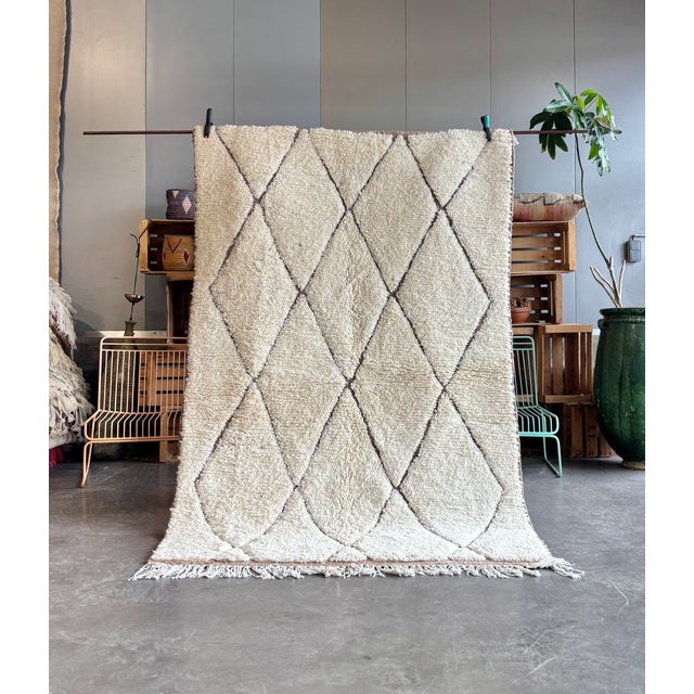 This authentic Moroccan Beni Ouarain rug is entirely handwoven by skilled Berber artisans in the Atlas Mountains using...