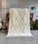 This authentic Moroccan Beni Ouarain rug is entirely handwoven by skilled Berber artisans in the Atlas Mountains using...
